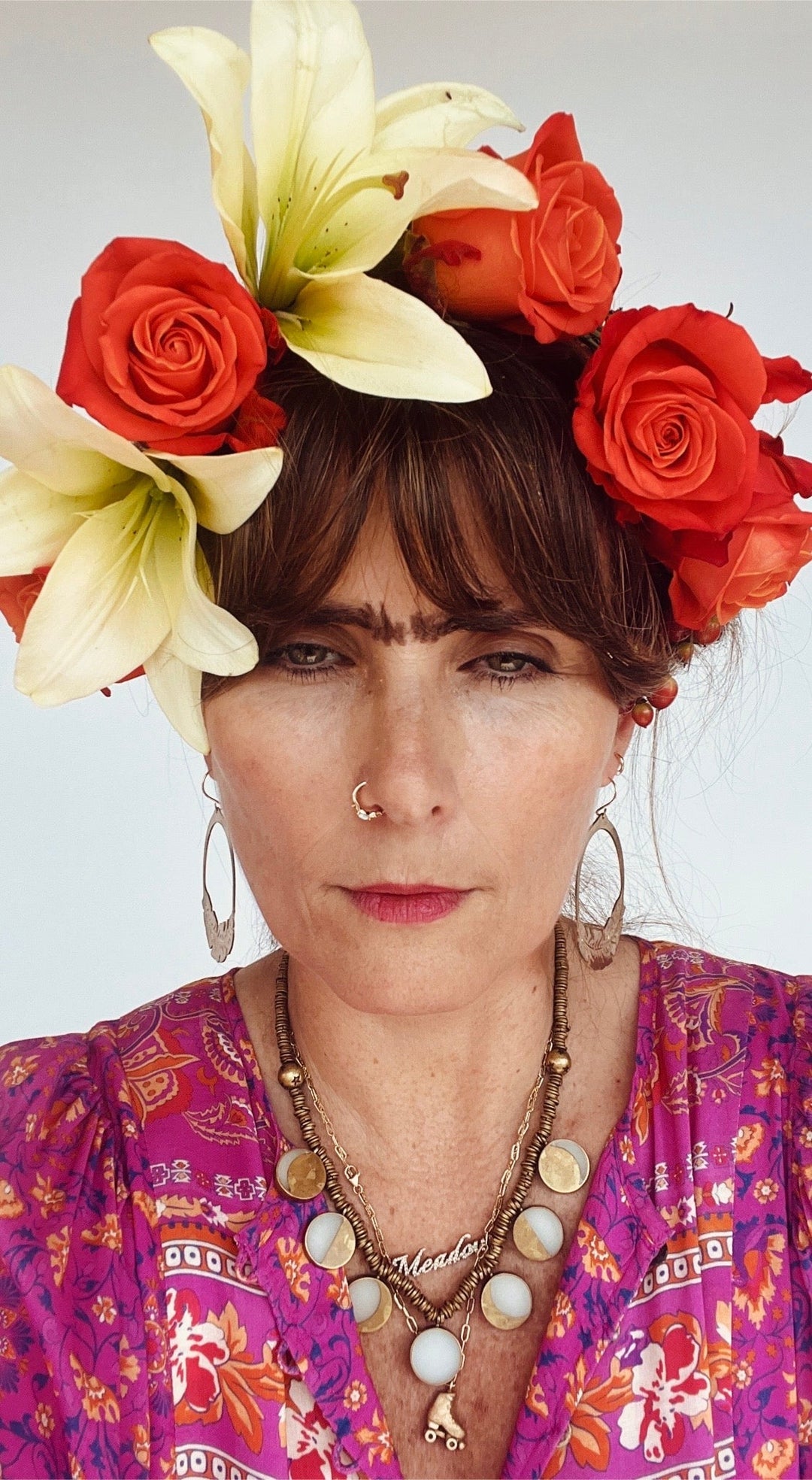 woman wearing flower crown and dressed for Halloween as Frida Khalo.