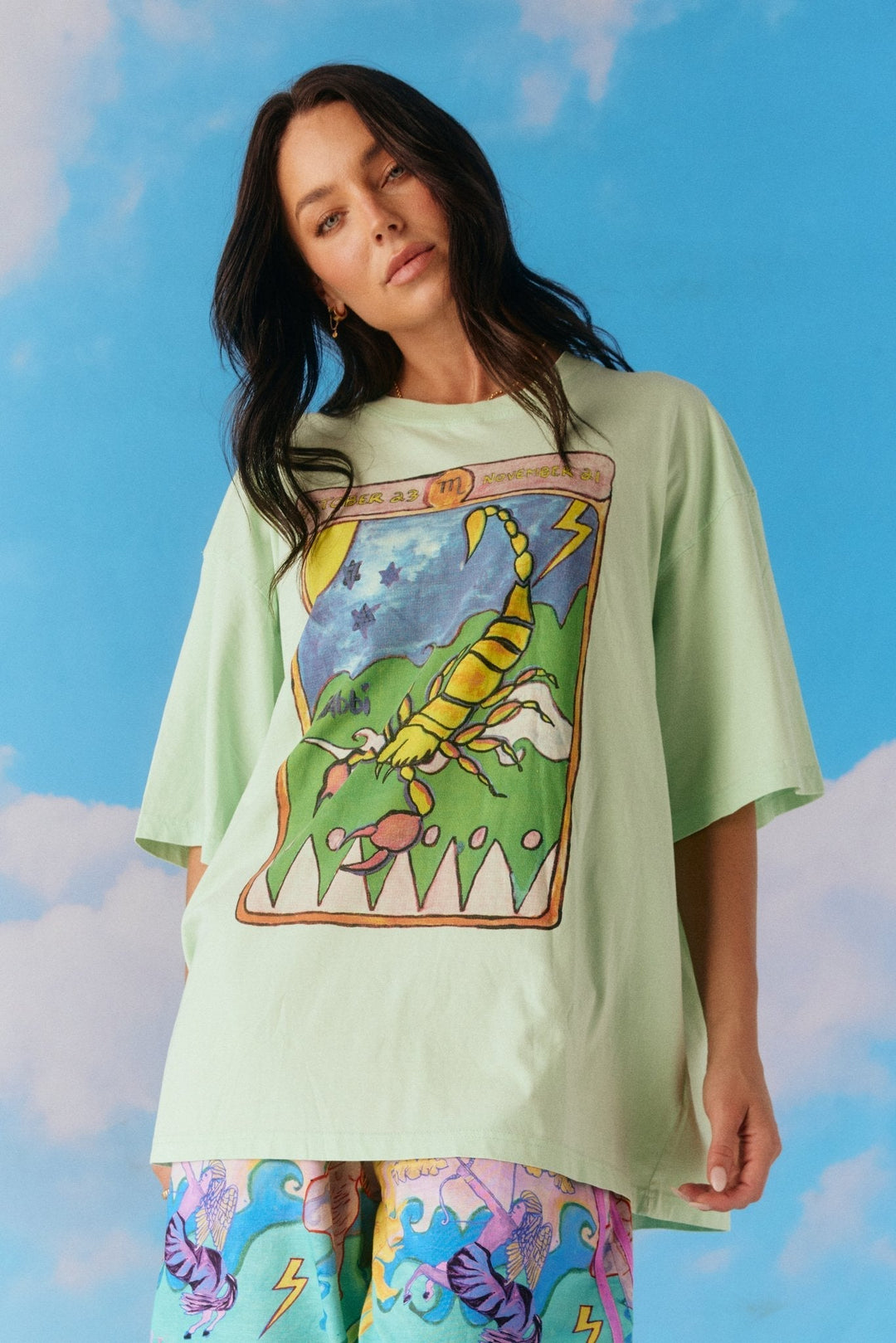 woman wearing green scorpio horoscope tee by Sabbi.