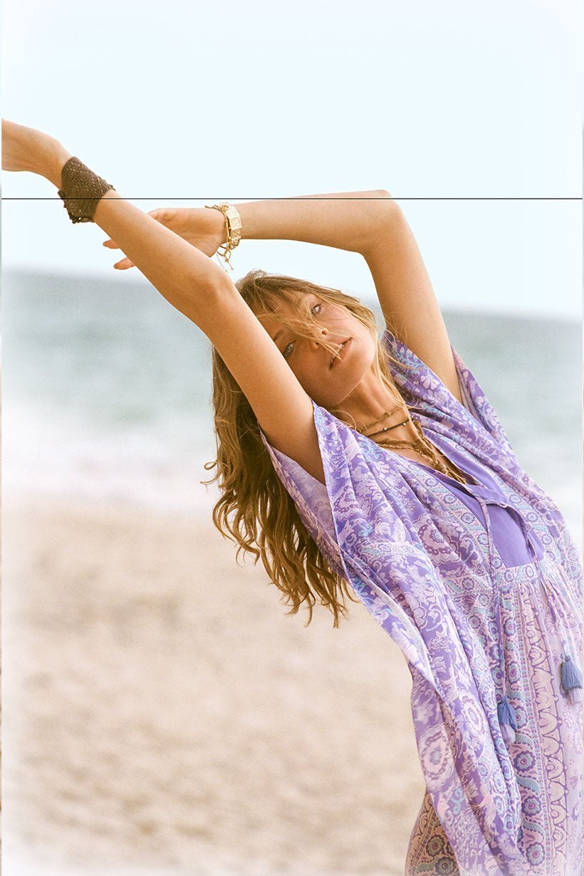 woman on beach in spell lilac caftan