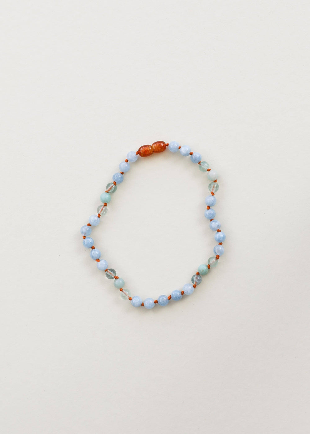 Aquamarine, fluorite and amazonite gemstone necklace laid flat