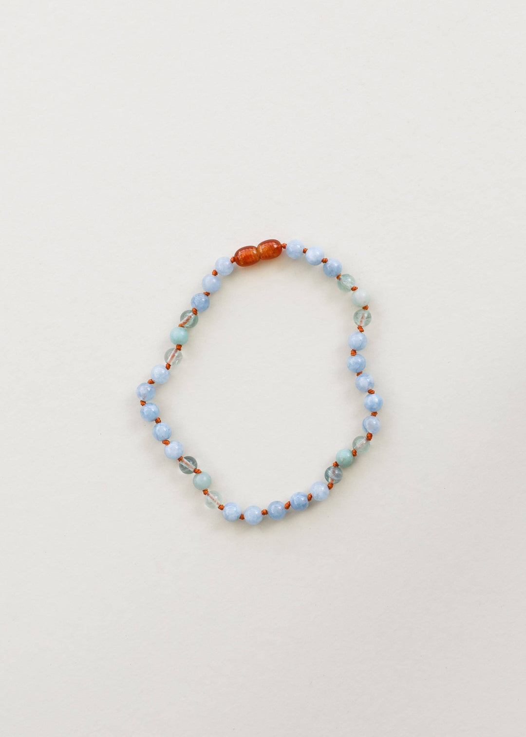 Aquamarine, fluorite and amazonite gemstone necklace laid flat
