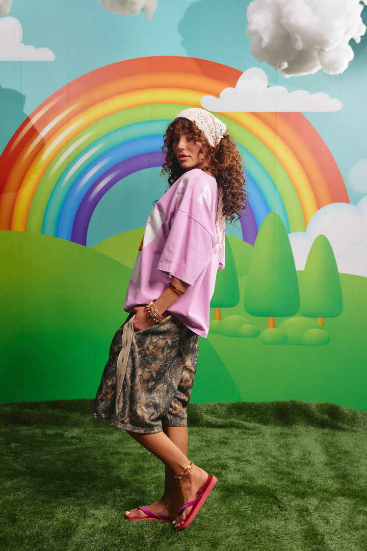 Side view of the oversized purple 77 tee showing the relaxed fit