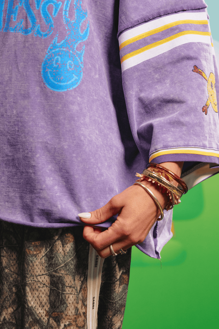 Close-up detail of the striped sleeve on the Glad Rag tee