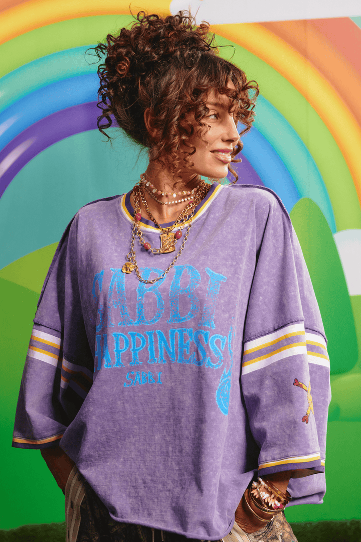 Sabbi Glad Rag tee in vintage purple, front view with distressed Happiness graphic