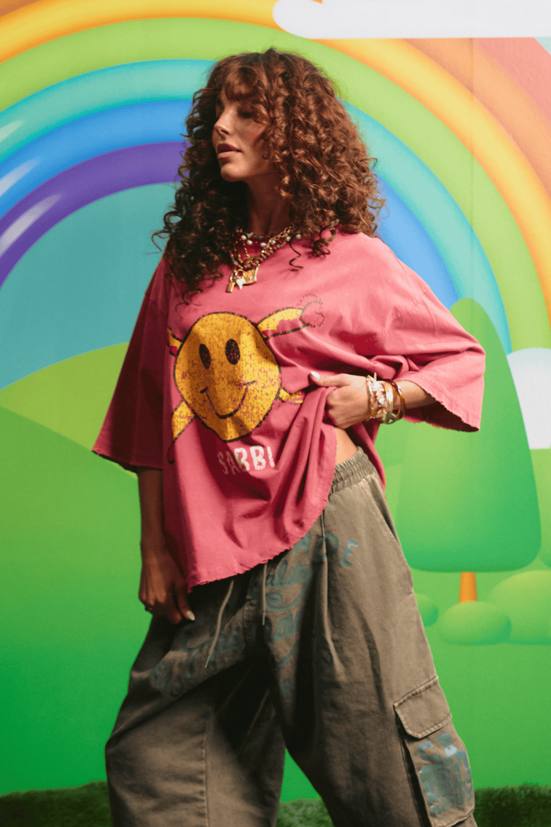 Side view of the oversized red Guy Smiley tee showing the relaxed fit