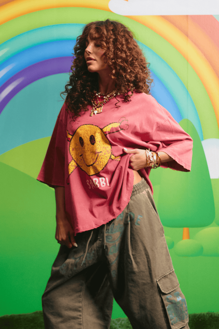 Side view of the oversized red Guy Smiley tee showing the relaxed fit