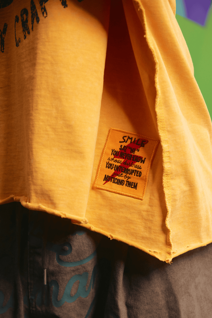 Close-up detail of the striped sleeve on the Happy Hour tee