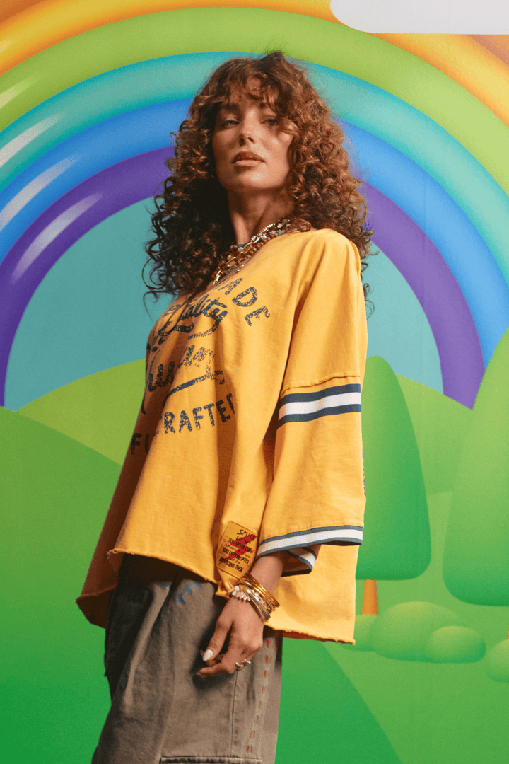 Side view of the oversized yellow Happy Hour tee showing the relaxed fit