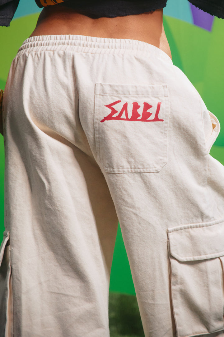 Close-up detail of the cargo pocket graphics on the cream jorts