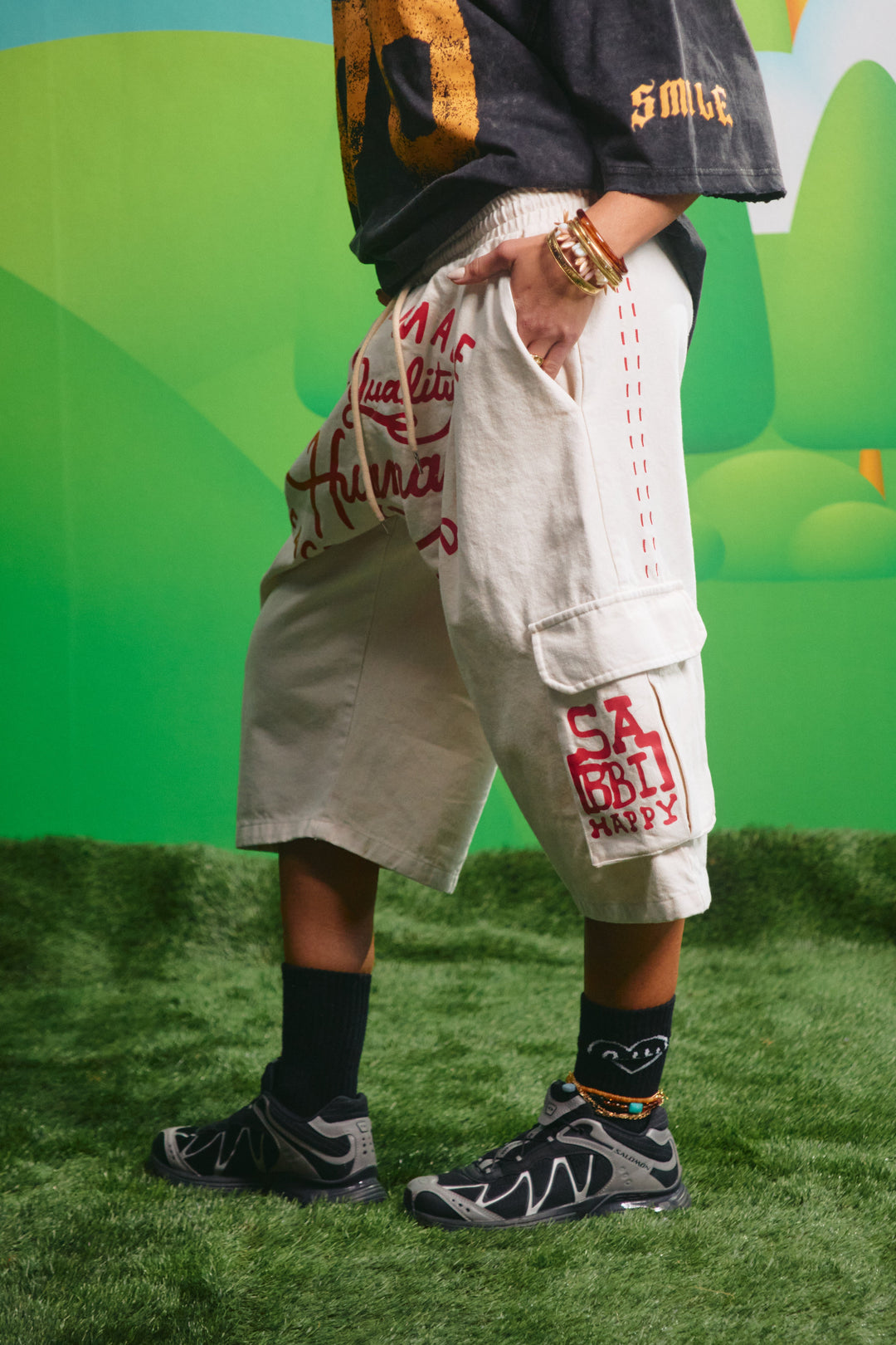 Side view of the oversized cream cargo jorts showing the relaxed fit