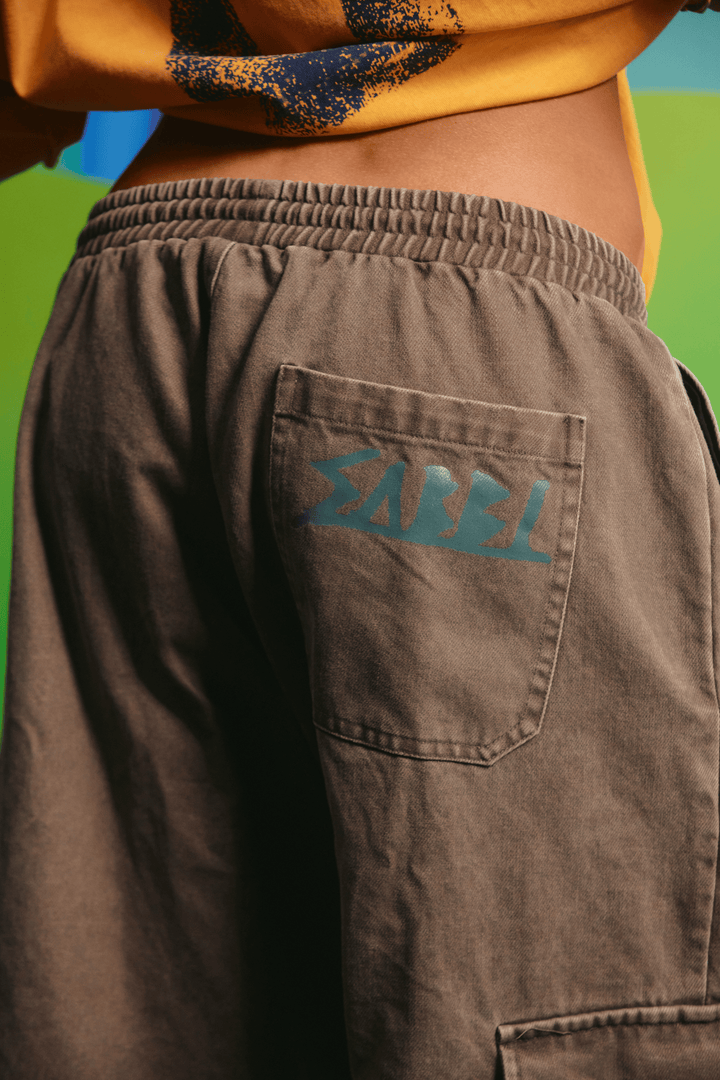 Close-up detail of the cargo pocket graphics on the khaki jorts