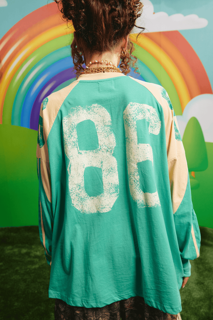 Back view of the green High Quality Human Long Sleeve Tee showing the 86 graphic