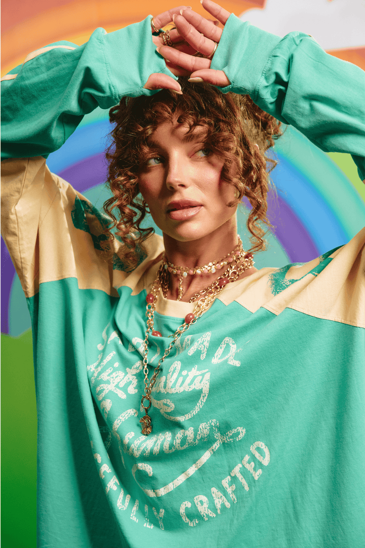 Close-up detail of the front graphic on the green tee