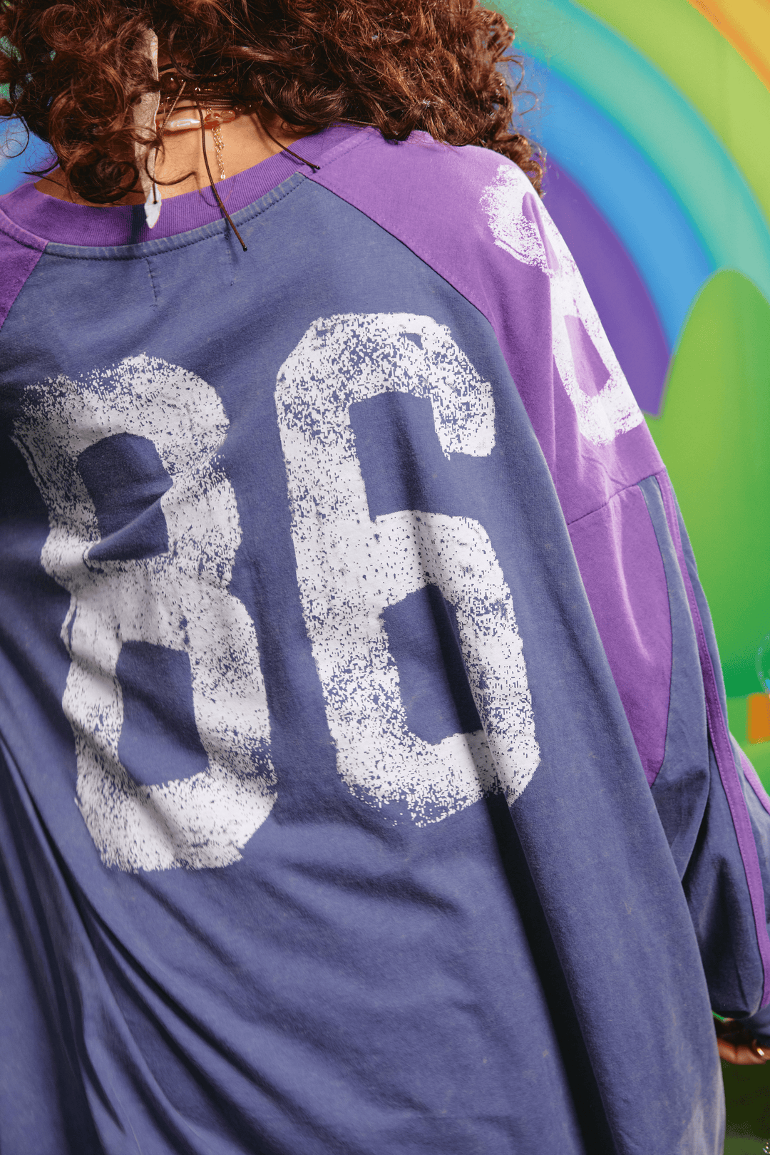 Close-up detail of the sleeve graphic on the purple tee
