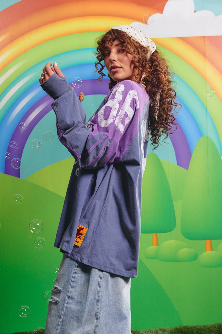 Side view of the purple High Quality Human Long Sleeve Tee showing the sleeve panel