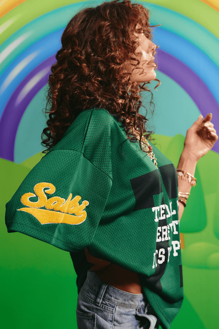 Side view of the oversized green Sabbi mesh tee