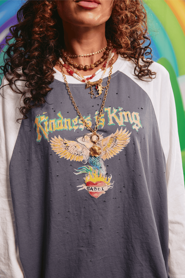 Close-up detail of the front artwork on the Raglan Kindness Is King tee