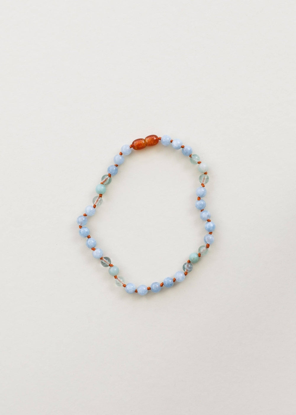 Aquamarine, fluorite and amazonite gemstone necklace laid flat