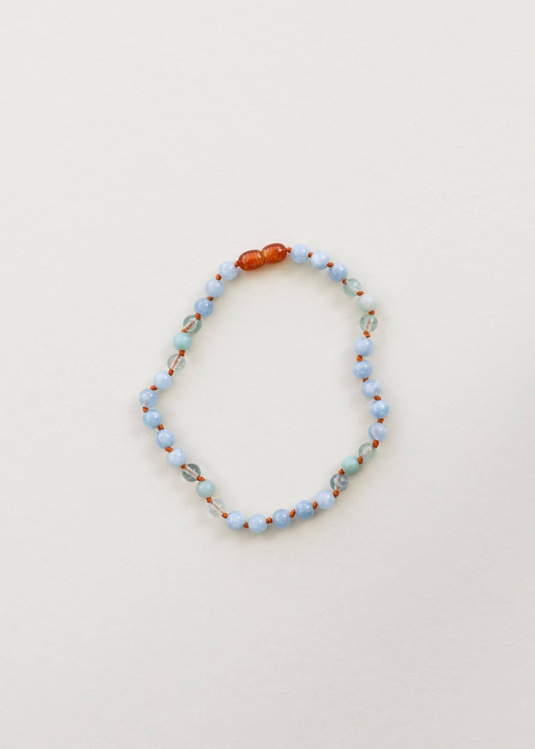Aquamarine, fluorite and amazonite gemstone necklace laid flat
