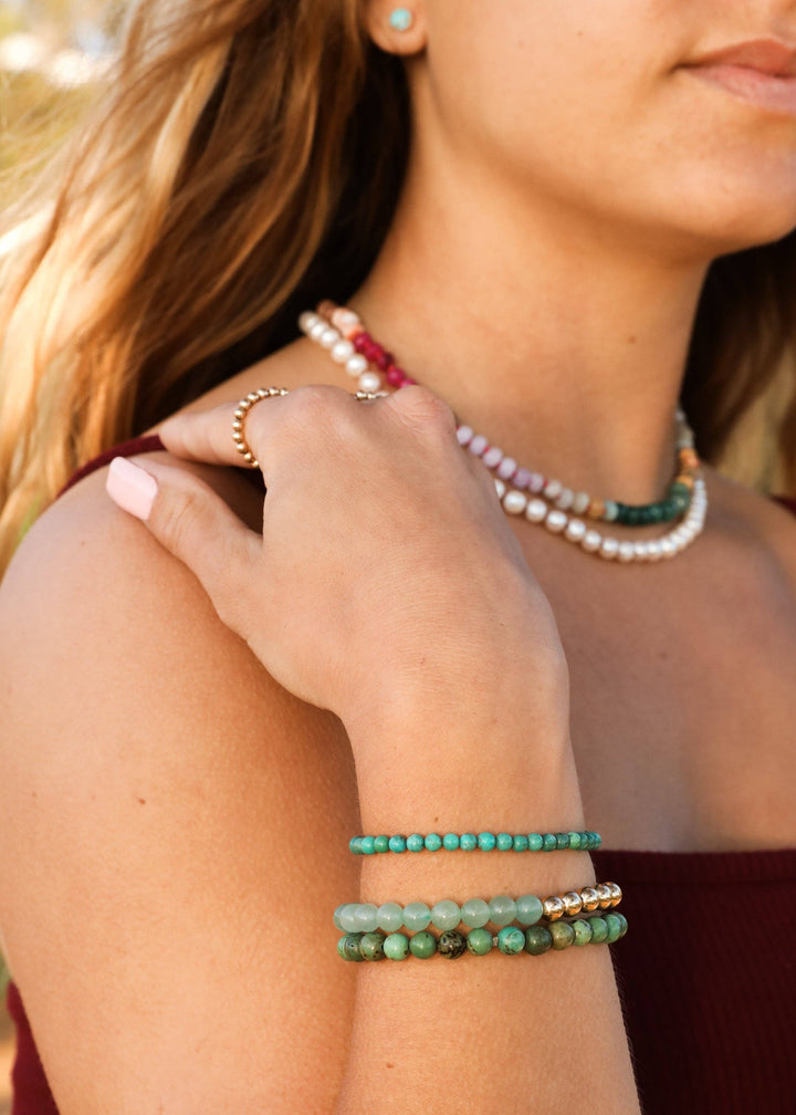 Sedona gemstone necklace layered with pearls and gemstone bracelets