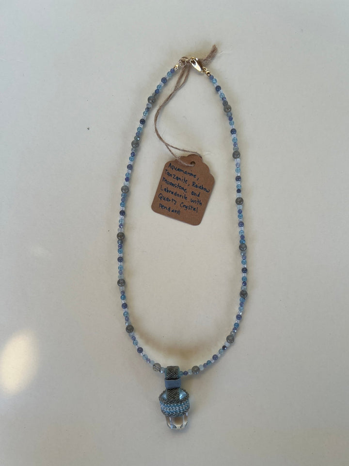 Necklace with blue beads and a tag on a white background