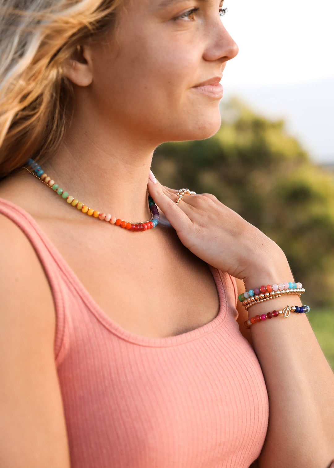 Woman wearing a CanyonLeaf rainbow gemstone necklace