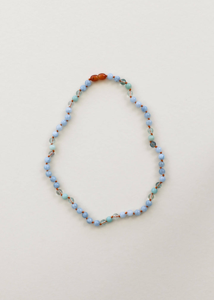 Close up of blue and green gemstone beads hand knotted on string