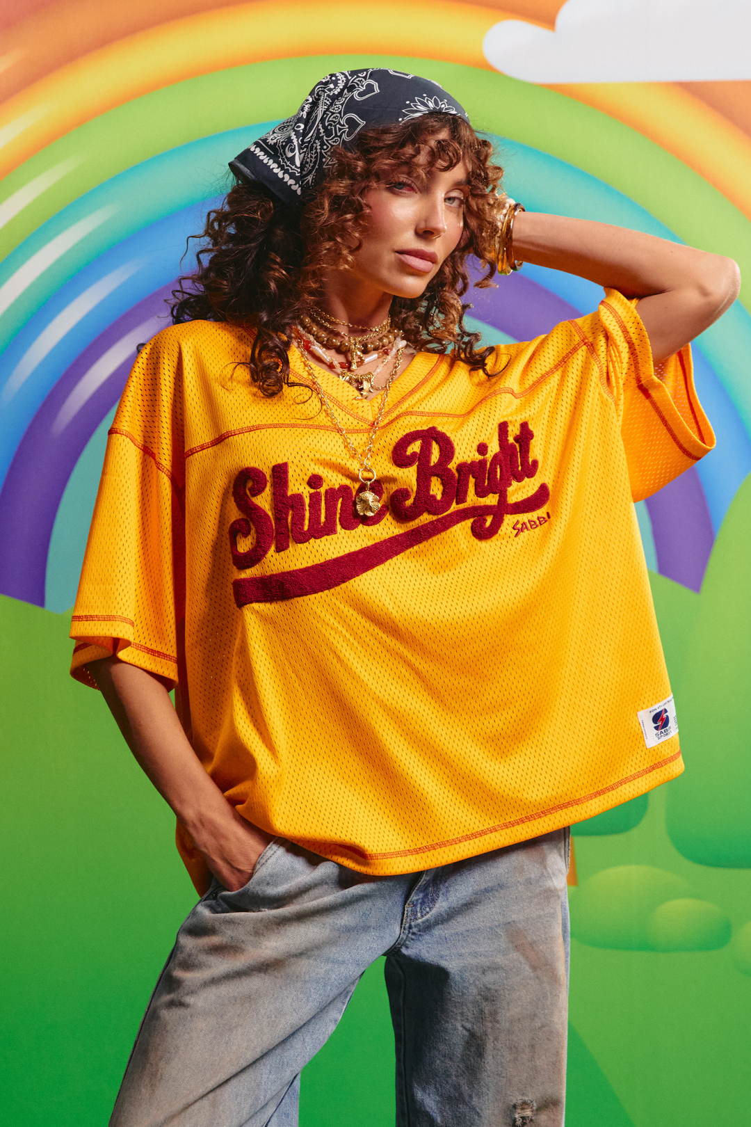 Sabbi Shine Bright mesh tee in yellow, front view with fuzzy lettering across the chest