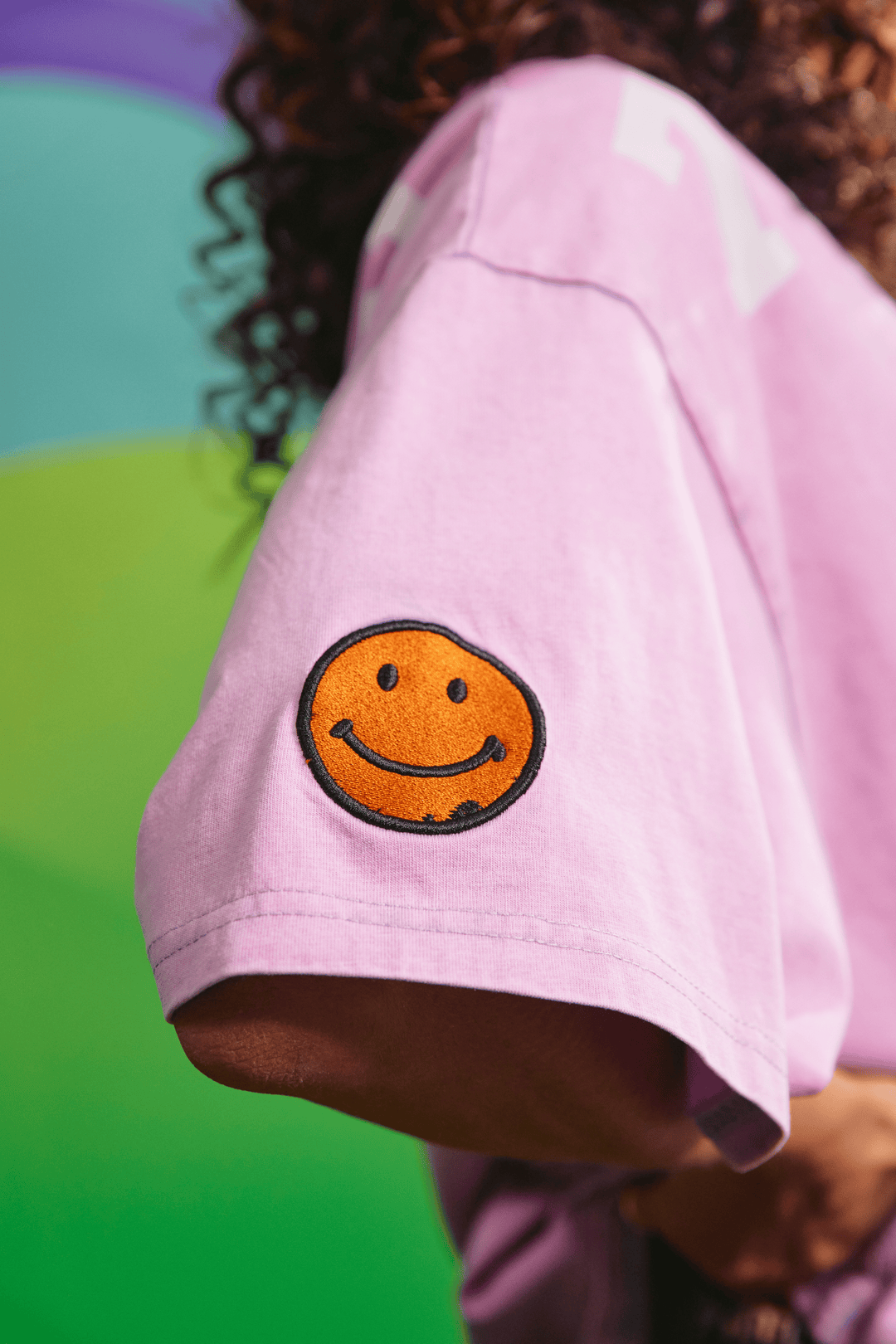Close-up detail of the front graphic texture on the purple 77 tee
