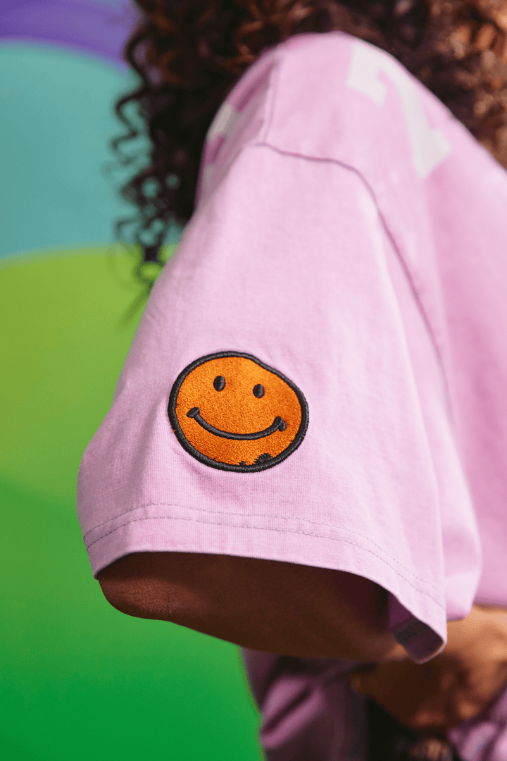 Close-up detail of the front graphic texture on the purple 77 tee