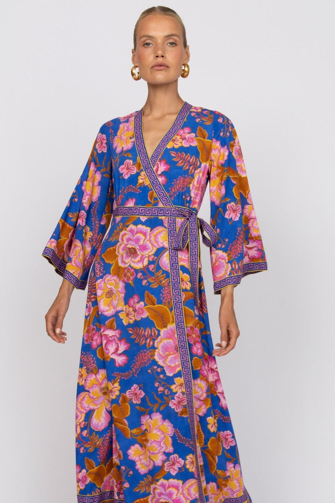 Woman wearing a colorful floral dress on a white background