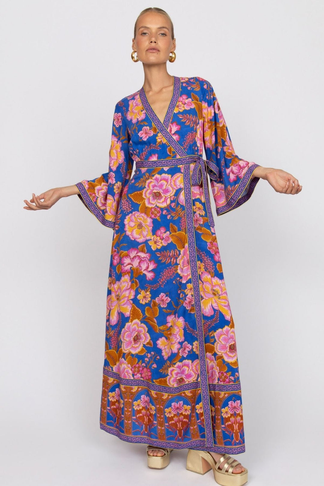 Woman wearing a colorful floral dress on a white background