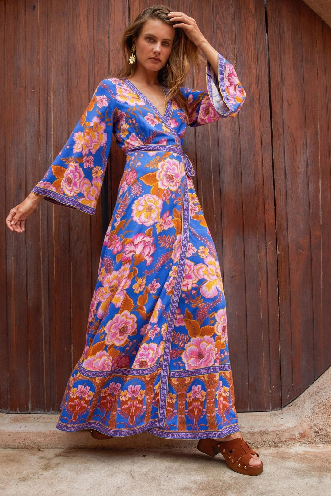 woman wearing maxi wrap dress in blue floral print