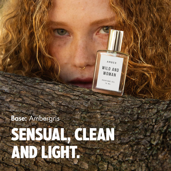 Woman with red curly hair holding Amber perfume oil, text reads Sensual, clean and light